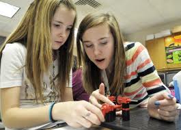 Students building mechanisms. 